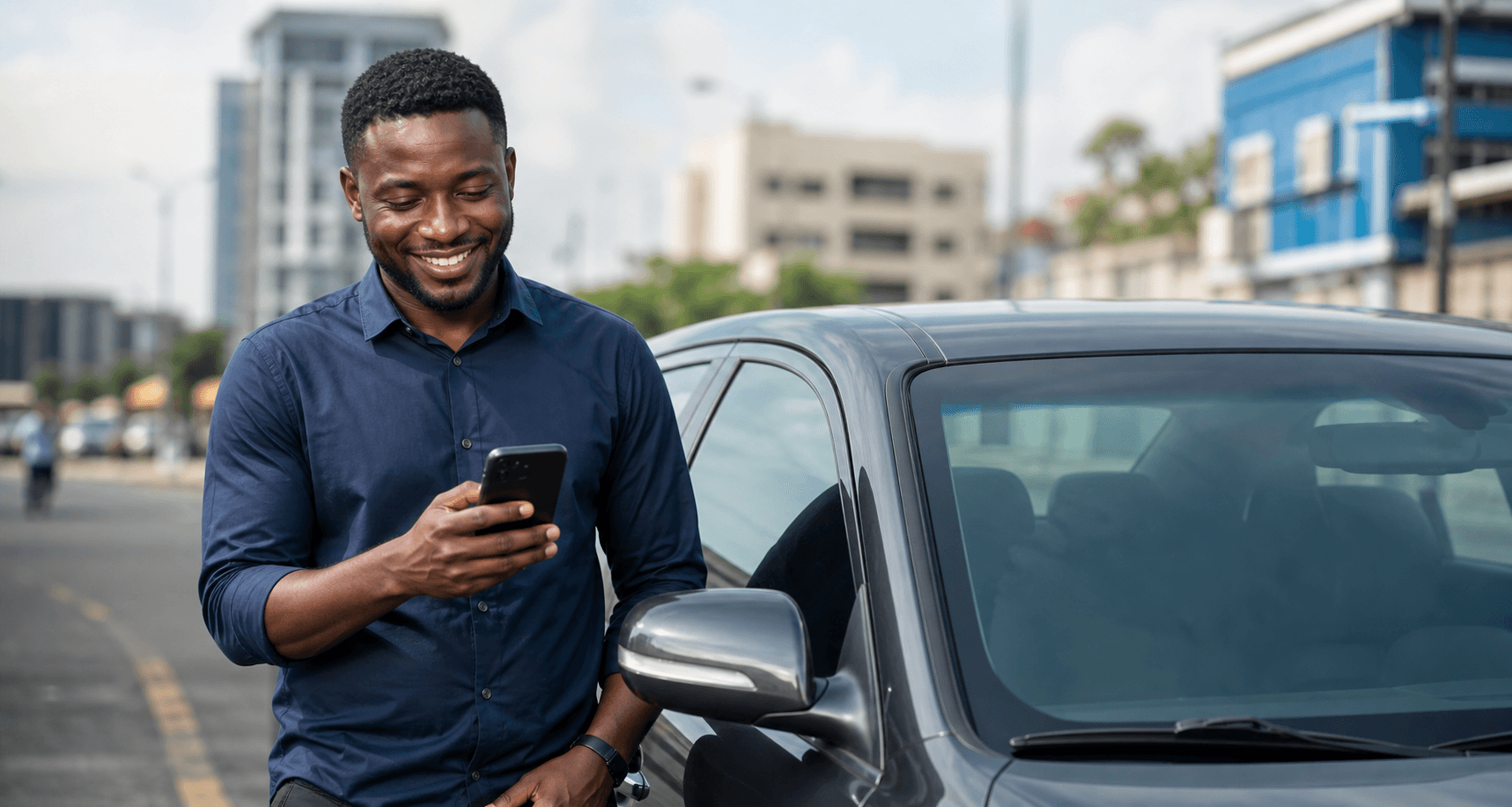 A driver partner smiling while checking a phone beside a car